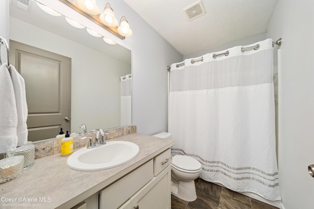 4281 N Shelburne Loop, Post Falls, ID 83854 - full bathroom featuring toilet, vanity, and a shower with shower curtain