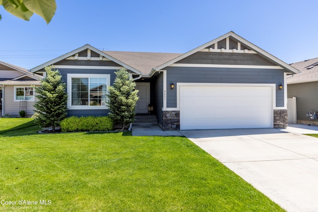 4281 N Shelburne Loop, Post Falls, ID 83854 - craftsman-style house featuring an attached garage, a front yard, concrete driveway, and stone siding