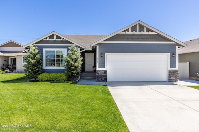 4281 N Shelburne Loop, Post Falls, ID 83854 - craftsman-style home with stone siding, a front yard, a garage, and driveway
