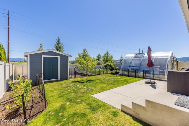 4281 N Shelburne Loop, Post Falls, ID 83854 - view of yard featuring a greenhouse, an outdoor structure, and a patio