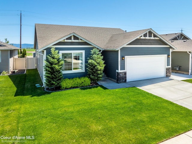 4281 N Shelburne Loop, Post Falls, ID 83854 - view of front of house with a shingled roof, a garage, and concrete driveway