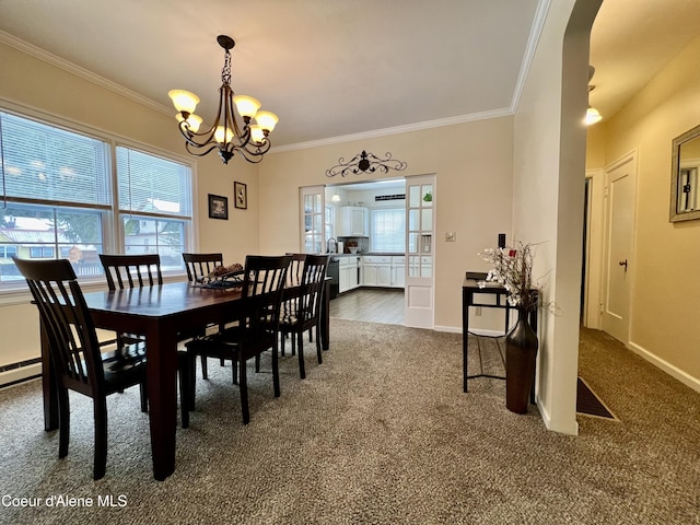 124 King St, Wallace, ID 83873 - dining area with ornamental molding, a chandelier, dark carpet, arched walkways, and baseboards