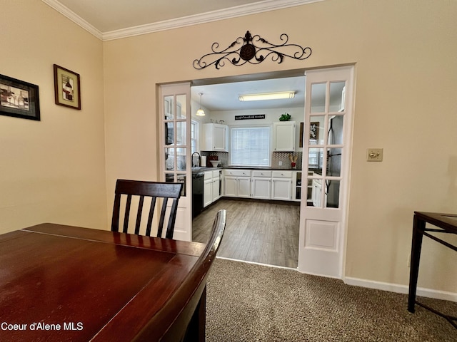 124 King St, Wallace, ID 83873 - unfurnished dining area featuring crown molding, a sink, and baseboards