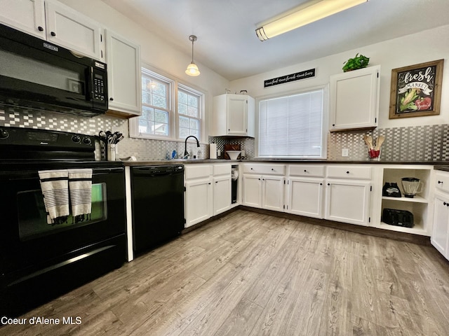 124 King St, Wallace, ID 83873 - kitchen with black appliances, white cabinetry, decorative backsplash, light wood finished floors, and dark countertops
