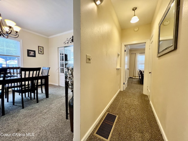 124 King St, Wallace, ID 83873 - corridor featuring dark carpet, a chandelier, ornamental molding, and baseboards