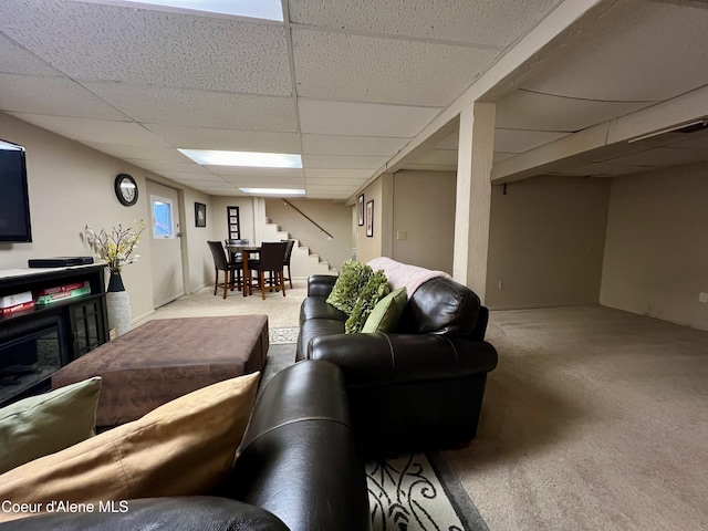 124 King St, Wallace, ID 83873 - living area featuring a drop ceiling, carpet floors, and stairway
