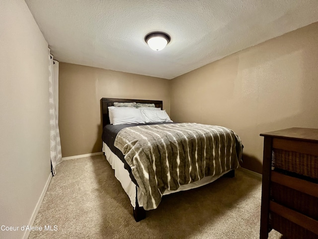 124 King St, Wallace, ID 83873 - carpeted bedroom featuring a textured ceiling and baseboards