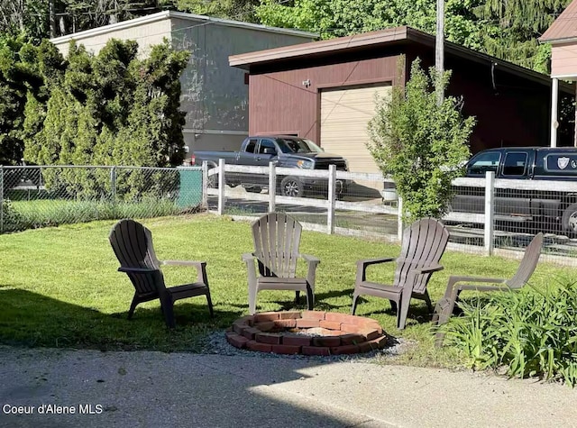 124 King St, Wallace, ID 83873 - view of yard with an outdoor structure, a fire pit, and a garage