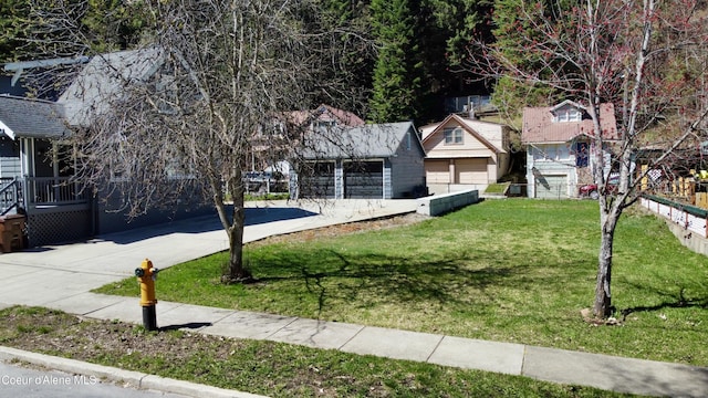 124 King St, Wallace, ID 83873 - obstructed view of property with a front yard, concrete driveway, and a garage