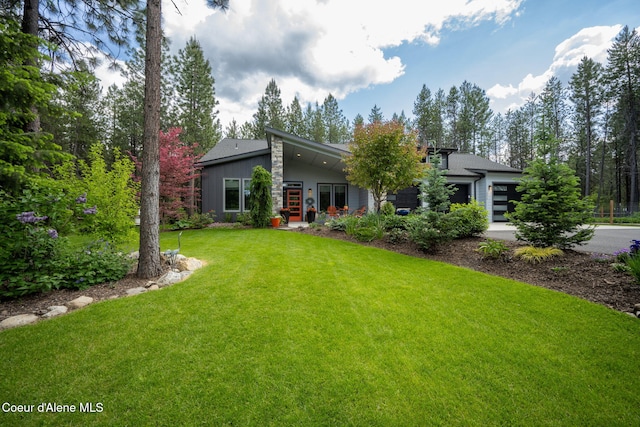 6036 W Sparrowhawk Dr, Rathdrum, ID 83858 - view of front facade featuring a garage, a front yard, driveway, board and batten siding, and french doors