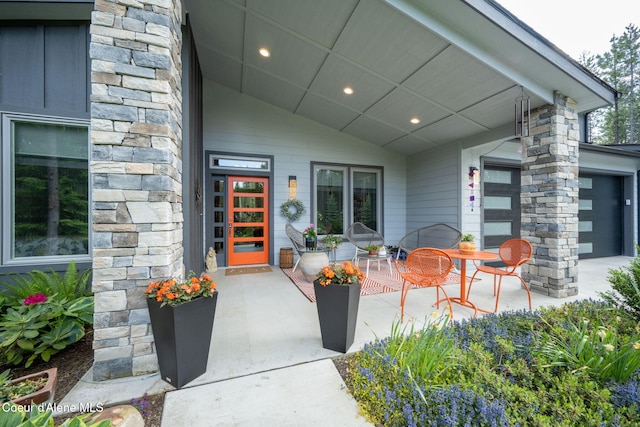 6036 W Sparrowhawk Dr, Rathdrum, ID 83858 - doorway to property featuring stone siding and an attached garage