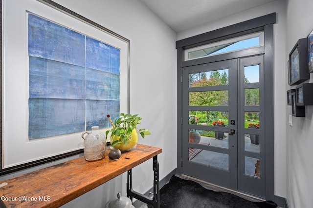 6036 W Sparrowhawk Dr, Rathdrum, ID 83858 - doorway to outside featuring dark colored carpet and baseboards
