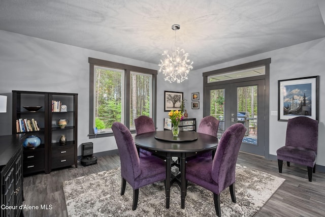 6036 W Sparrowhawk Dr, Rathdrum, ID 83858 - dining space featuring a chandelier, wood finished floors, french doors, and baseboards