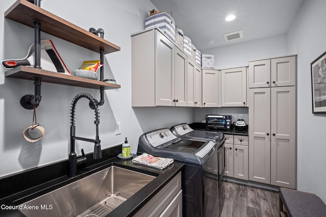 6036 W Sparrowhawk Dr, Rathdrum, ID 83858 - washroom with washing machine and clothes dryer, cabinet space, dark wood finished floors, and recessed lighting