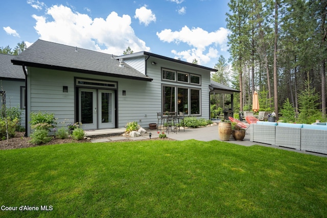 6036 W Sparrowhawk Dr, Rathdrum, ID 83858 - rear view of property featuring outdoor lounge area, a patio area, a lawn, and roof with shingles
