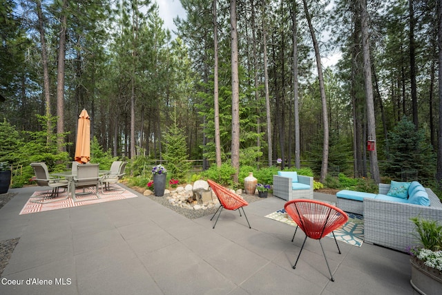 6036 W Sparrowhawk Dr, Rathdrum, ID 83858 - view of patio / terrace featuring outdoor lounge area, outdoor dining space, and a view of trees
