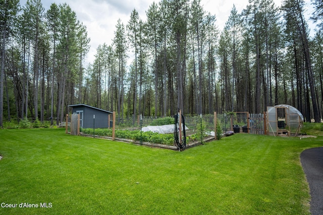 6036 W Sparrowhawk Dr, Rathdrum, ID 83858 - view of yard with a vegetable garden, a greenhouse, and an outdoor structure