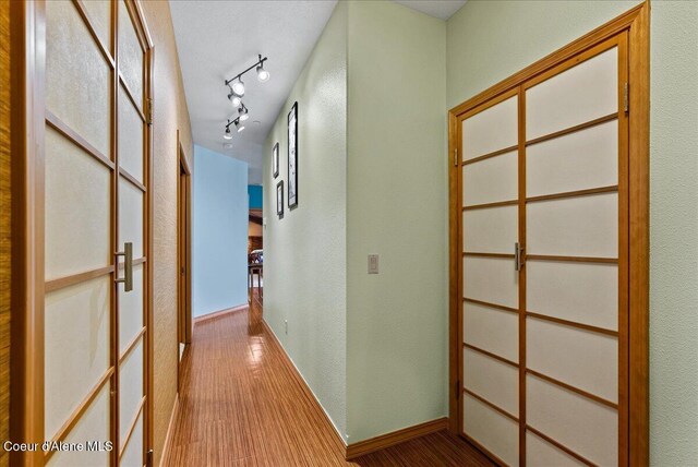 1010 E Mullan Ave Unit 202, Coeur Dalene, ID 83814 - hall featuring wood finished floors, baseboards, and a textured wall