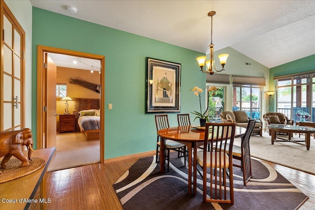 1010 E Mullan Ave Unit 202, Coeur Dalene, ID 83814 - dining area with hardwood / wood-style floors, vaulted ceiling, a chandelier, and baseboards