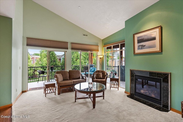 1010 E Mullan Ave Unit 202, Coeur Dalene, ID 83814 - living area featuring carpet floors, vaulted ceiling, baseboards, and a premium fireplace