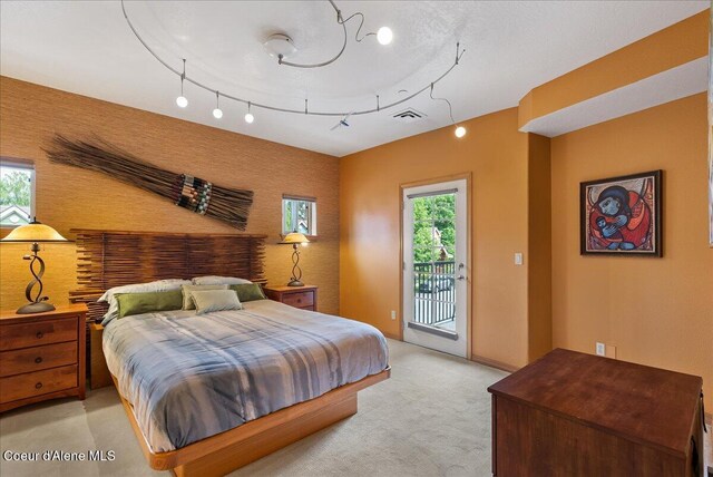1010 E Mullan Ave Unit 202, Coeur Dalene, ID 83814 - bedroom with access to outside, light colored carpet, and an accent wall