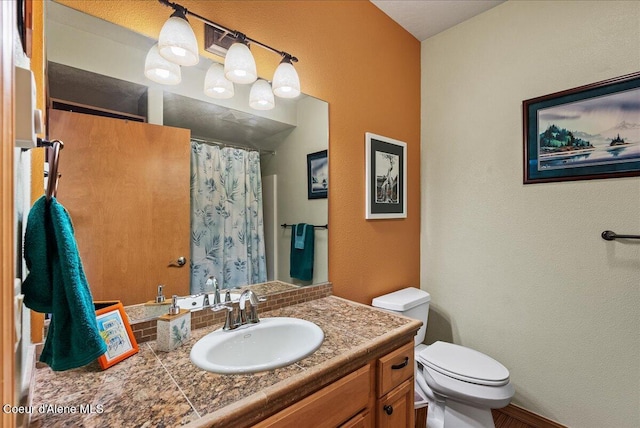 1010 E Mullan Ave Unit 202, Coeur Dalene, ID 83814 - bathroom with toilet, vanity, a textured wall, and a shower with curtain