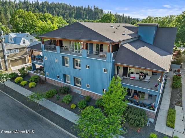 1010 E Mullan Ave Unit 202, Coeur Dalene, ID 83814 - aerial view of property and surrounding area with a forest