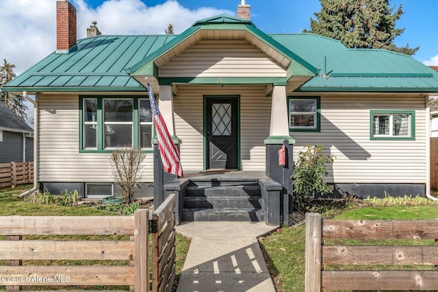 721 N A St, Coeur Dalene, ID 83814 - bungalow-style home with a chimney, metal roof, and a standing seam roof