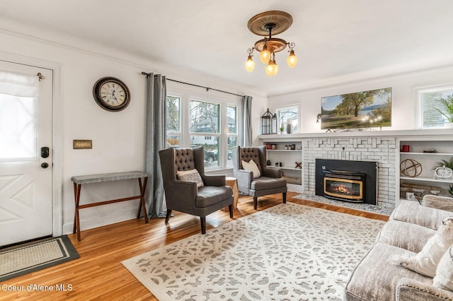 721 N A St, Coeur Dalene, ID 83814 - living area with light wood-type flooring, a fireplace, crown molding, and baseboards