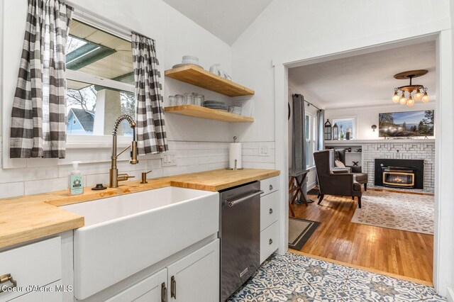 721 N A St, Coeur Dalene, ID 83814 - kitchen featuring wood counters, a sink, dishwasher, light wood-style flooring, and lofted ceiling