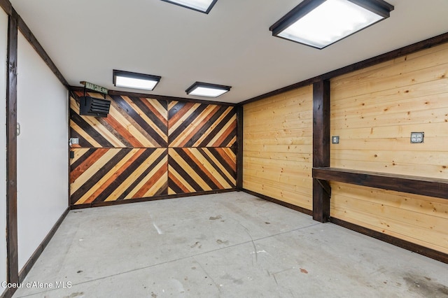 721 N A St, Coeur Dalene, ID 83814 - empty room featuring concrete floors, baseboards, and wooden walls
