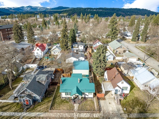721 N A St, Coeur Dalene, ID 83814 - aerial view of residential area featuring a mountain backdrop and a heavily wooded area