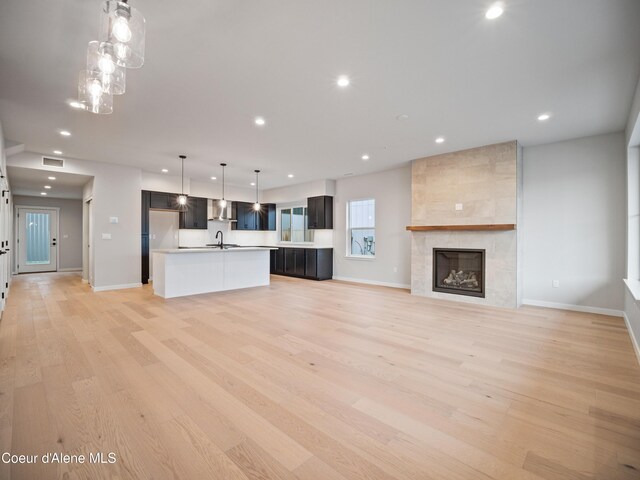 997 E Railroad Ave, Post Falls, ID 83854 - unfurnished living room with light wood-style floors, recessed lighting, baseboards, and a fireplace