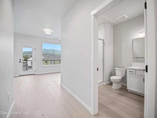 997 E Railroad Ave, Post Falls, ID 83854 - bathroom featuring toilet, vanity, wood finished floors, a shower stall, and baseboards