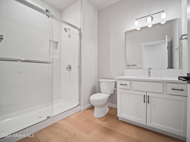 997 E Railroad Ave, Post Falls, ID 83854 - full bath with toilet, a shower stall, vanity, and wood finished floors