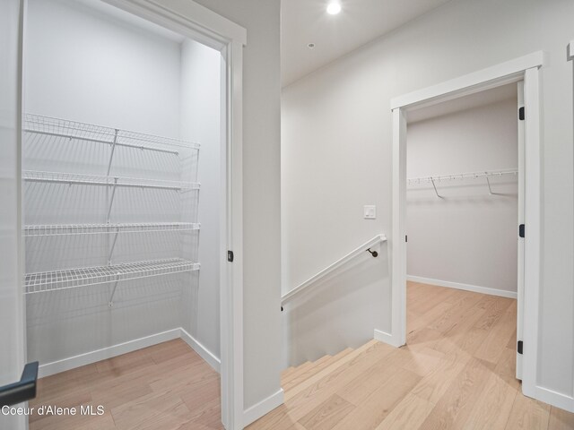 997 E Railroad Ave, Post Falls, ID 83854 - corridor featuring wood finished floors, an upstairs landing, baseboards, and recessed lighting