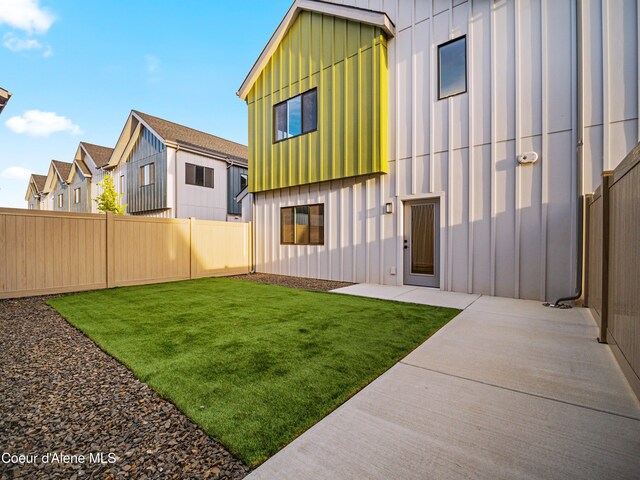 997 E Railroad Ave, Post Falls, ID 83854 - back of property with board and batten siding, a patio area, and a residential view