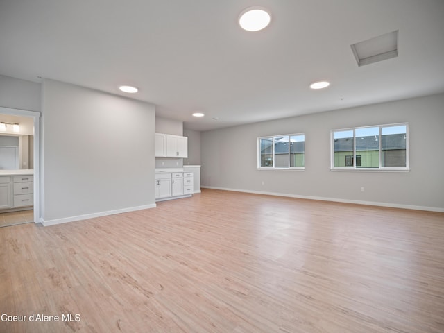 997 E Railroad Ave, Post Falls, ID 83854 - unfurnished living room featuring light wood-type flooring, baseboards, and recessed lighting