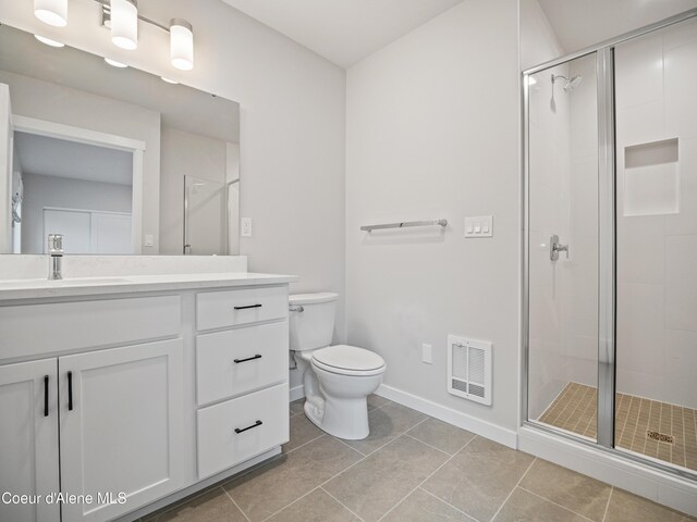 997 E Railroad Ave, Post Falls, ID 83854 - full bathroom featuring vanity, toilet, a shower stall, and baseboards