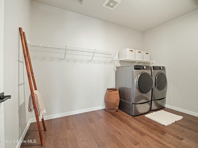 1031 E Railroad Ave, Post Falls, ID 83854 - laundry room with washer and dryer, wood finished floors, and baseboards