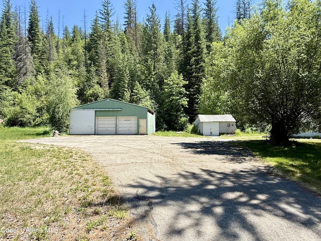 1068 Moon Gulch Rd, Kellogg, ID 83837 - detached garage featuring a view of trees