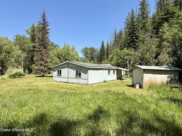1068 Moon Gulch Rd, Kellogg, ID 83837 - rear view of property featuring a lawn and a view of trees