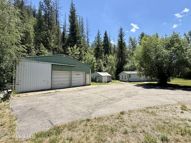 1068 Moon Gulch Rd, Kellogg, ID 83837 - detached garage featuring a view of trees