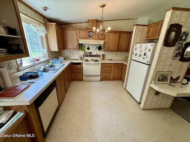 1068 Moon Gulch Rd, Kellogg, ID 83837 - kitchen featuring white appliances, under cabinet range hood, brown cabinetry, wallpapered walls, and light countertops