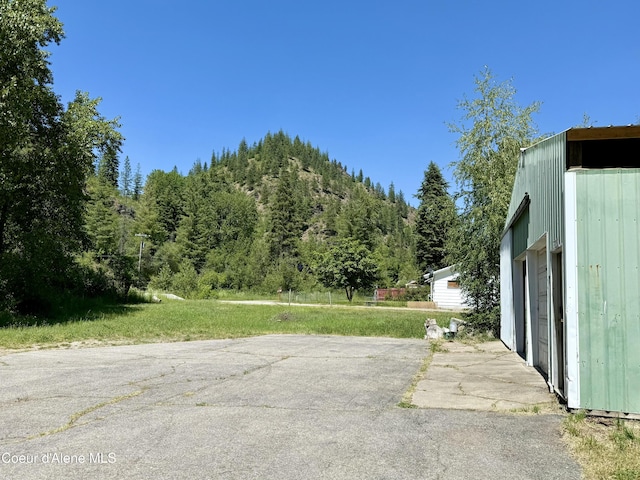 1068 Moon Gulch Rd, Kellogg, ID 83837 - view of vehicle parking featuring a wooded view and a mountain view