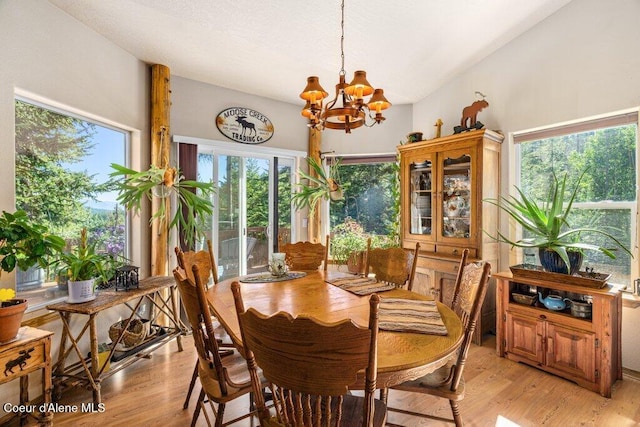 17461 N Right Fork Rd, Hauser, ID 83854 - dining room featuring a chandelier, light wood finished floors, and plenty of natural light