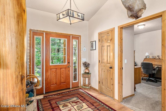 17461 N Right Fork Rd, Hauser, ID 83854 - entryway featuring wood finished floors, baseboards, and lofted ceiling