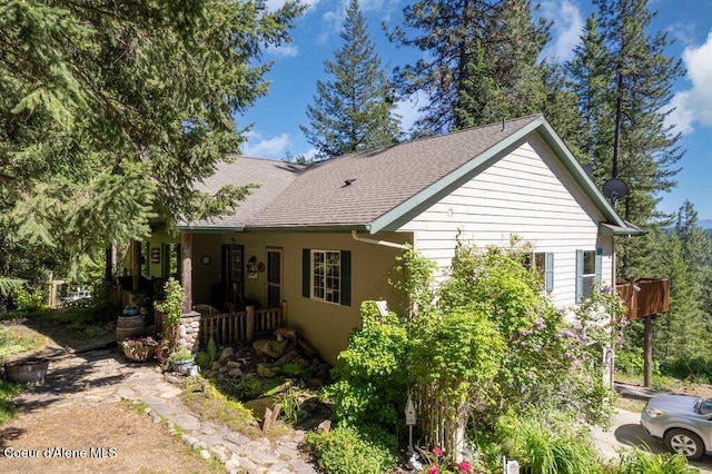17461 N Right Fork Rd, Hauser, ID 83854 - rear view of property with a shingled roof and covered porch