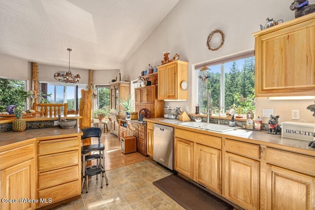 17461 N Right Fork Rd, Hauser, ID 83854 - kitchen with dishwasher, a sink, a chandelier, light brown cabinetry, and a textured ceiling