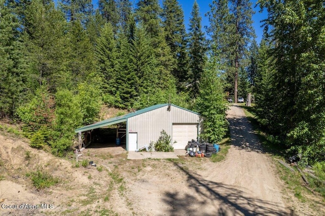 17461 N Right Fork Rd, Hauser, ID 83854 - view of outdoor structure featuring driveway and a wooded view